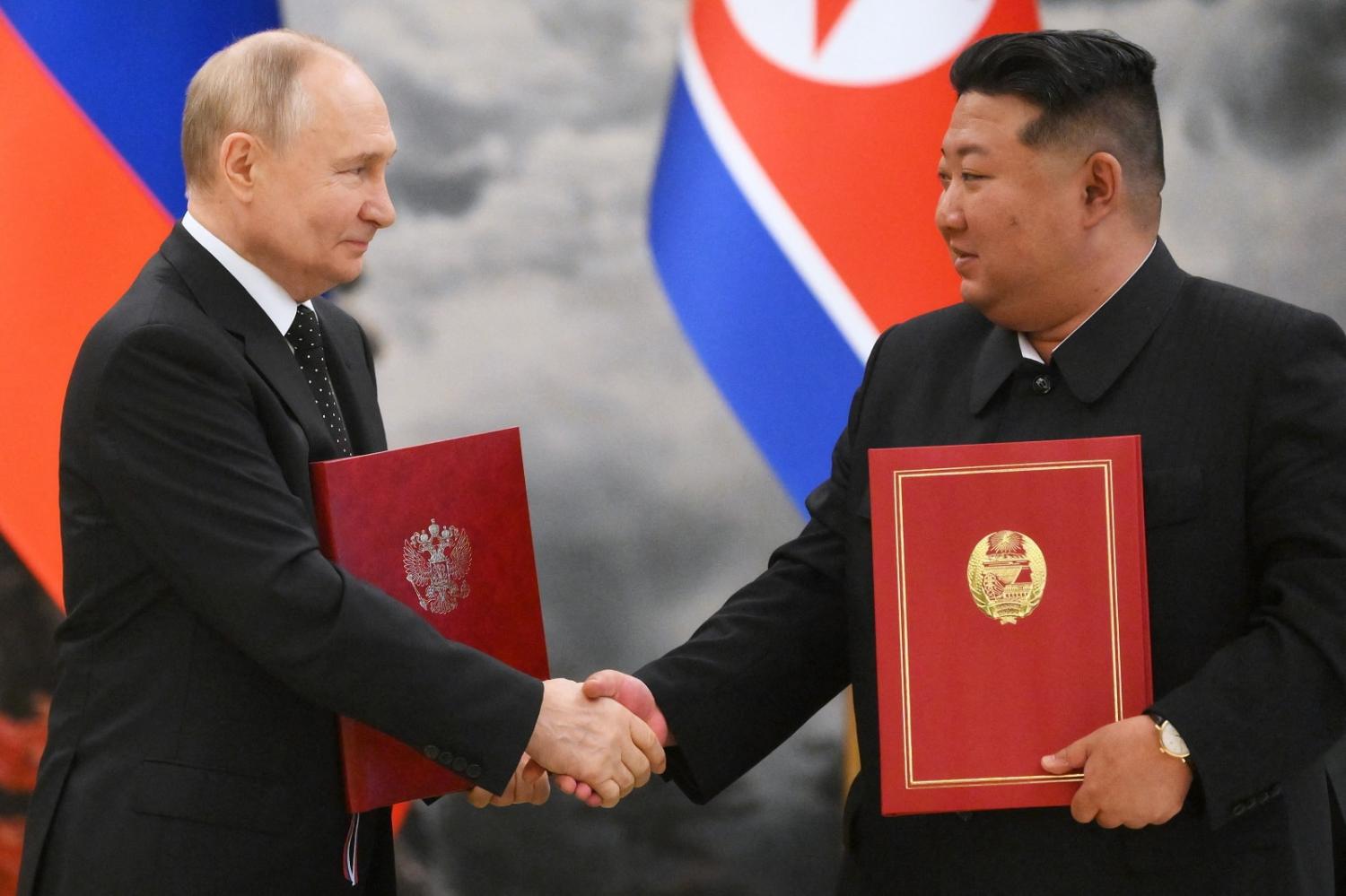 Russian President Vladimir Putin (L) shakes hands with North Korea's leader Kim Jong-un after a signing ceremony in Pyongyang, 19 June 2024 (Kristina Kormilitsyna/Sputnik/AFP Pool Via Getty Images)